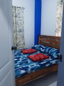 a bed with two pillows on it in a room at Baguio La Famille Residences in Baguio