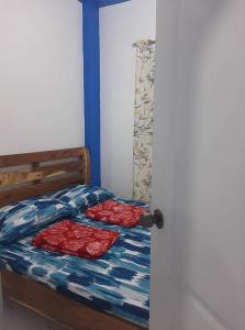 a bedroom with a bed with two red sheets at Baguio La Famille Residences in Baguio