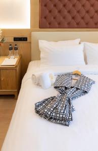 a white bed with two towels on top of it at Heaven Boutique Hotel in Bangkok +31 photos