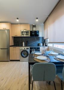 a kitchen with a table and chairs and a refrigerator at Villa Hita apartment by People Rentals in Bilbao
