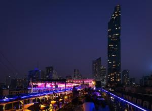 a city skyline at night with purple and pink lights at Heaven Boutique Hotel in Bangkok