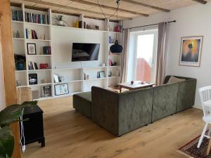 a living room with a couch and a table at Newly renovated house with garden and ocean view in Tórshavn