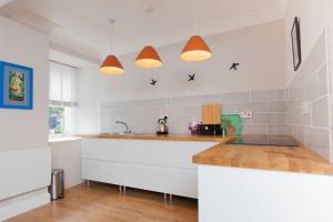a white kitchen with a counter and a sink at East Linton flat, sleeps 2 in East Linton