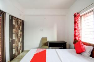 Flagship Hotel Creation Premium في Sānkchi: غرفة نوم بسرير ومكتب ونافذة