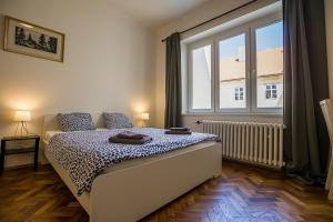 a bedroom with a bed and a large window at Best View Apartments in Bratislava