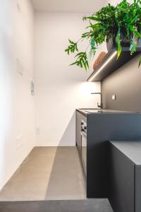 a kitchen with a sink and a stove at Ortigia's gate in Siracusa