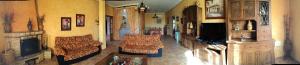 a living room with a couch and a fireplace at Casa Rural La Higuera I Puy du Fou in Pulgar