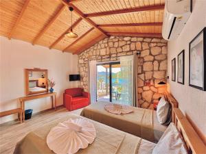 a bedroom with two beds and a stone wall at Kaş Köy Hotel in Kaş