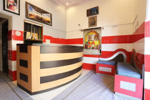 a bar in a restaurant with red and white stripes at Hotel O Vanshika in Agra