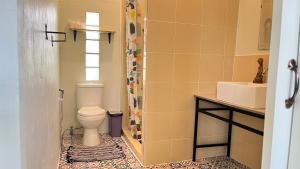 a bathroom with a toilet and a sink at Bannamhoo Bungalows in Pai