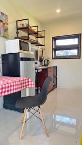a black chair in a kitchen with a table at Bannamhoo Bungalows in Pai