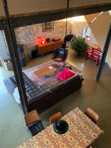 a living room with a couch and a table at gerestaureerde hoeve met zicht in Durbuy