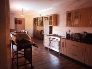 uma cozinha com um piano e uma sala de estar em Beautiful guesthouse with pool and solar - 2057 em Victoria Falls