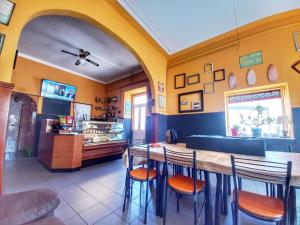 um restaurante com uma mesa e cadeiras num quarto em Meraki Hostel em Sintra