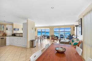 cocina y sala de estar con vistas al océano en Bluewater at Mannering Park, en Mannering Park