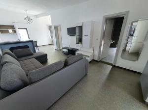 a living room with a couch and a television at Seaside Inn & Suites in Costinesti
