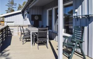 a deck with chairs and a table on a house at Awesome Home In Sandefjord With Wifi in Sandefjord