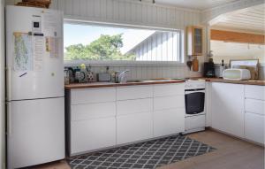 a kitchen with white cabinets and a white refrigerator at Awesome Home In Sandefjord With Wifi in Sandefjord