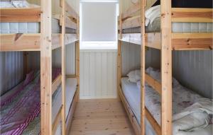 two bunk beds in a room with a window at Awesome Home In Sandefjord With Wifi in Sandefjord