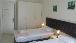a small bedroom with two beds and a mirror at Summer House by the Sea - 40 m to the beach in Side