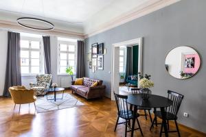 a living room with a table and a couch at New Stylish 3 Suites Bedrooms Apt in Mala Strana - N2nd in Prague