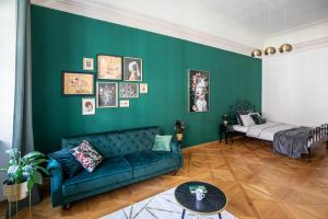 a green living room with a couch and a bed at New Stylish 3 Suites Bedrooms Apt in Mala Strana - N2nd in Prague