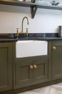 a kitchen with a sink and a counter top at Farriers Cottage-Tranquil Haven, Central Location! in Hexham