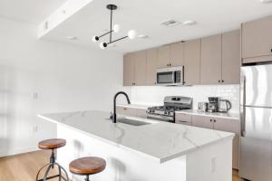 a kitchen with white cabinets and a large counter top at Hoboken 1BR w Elevator Gym Terrace Courtyard NYC-790 in Hoboken