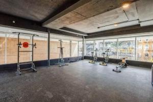 a gym with several treadmills and a basketball hoop at Hoboken 1BR w Elevator Gym Terrace Courtyard NYC-790 in Hoboken