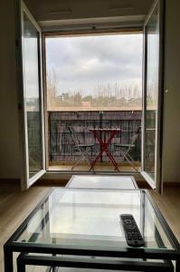 a glass table with a remote control on top of it at Studio Sainte Victoire avec balcon in Aix-en-Provence