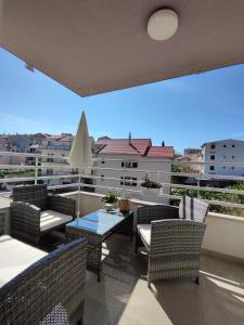 a balcony with chairs and a table on a balcony at Lucy Apartment Split in Split