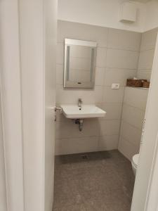 a bathroom with a sink and a mirror at Lucy Apartment Split in Split