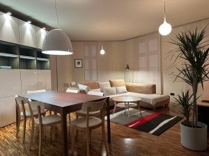 a living room with a table and a couch at Triple Bridge Ljubljana in Ljubljana