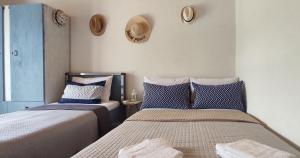 a bedroom with two beds and a window at ANASA in Stavros