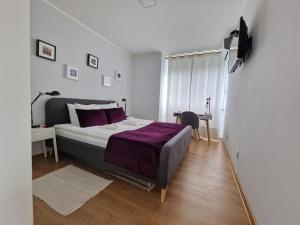 a bedroom with a bed and a desk in a room at Usce Downtown Apartment in Belgrade