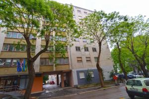 an apartment building on a city street with trees at Apartment Marija 2238 in Pula