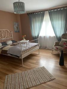 a bedroom with a bed and a large window at Sinan's Bio Tourismus Farm Appartement in Betteldorf
