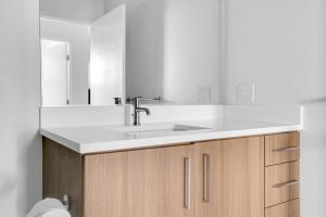 a white bathroom with a sink and a mirror at Redwood City 1BR w Roof Gym WD nr Caltrain SFO-959 in Redwood City +24 photos