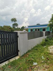 a fence in front of a house at Lanai Meranti in Ipoh