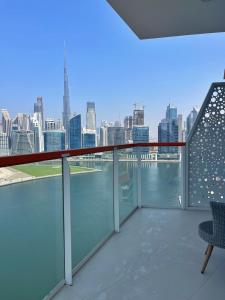 a balcony with a view of the city at Dubai Canal Burj khalifa view 2bedroom apartment in Al Ḩamīdīyah