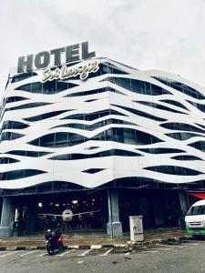 a hotel building with a motorcycle parked in front of it at Sri Langit Hotel KLIA, KLIA 2 & F1 in Sepang
