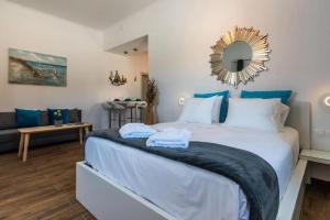 a bedroom with a large bed with a mirror on the wall at Island Dreams in Adamantas