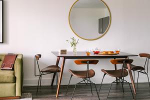 a dining room table with a mirror and stools at Sonder Midtown South in Atlanta
