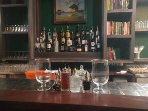 a bar with several glasses and bottles of alcohol at PROVINCE FIVE HOTEL in Bhairāhawā