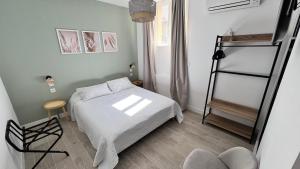 a small bedroom with a bed and a ladder at Les Paquebots - Hôtel & Restaurant in Port-Vendres