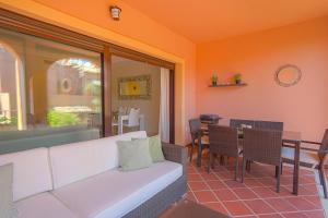 a living room with a white couch and a table at Townhouse Azata Golf in Estepona