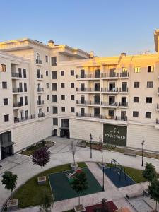 an apartment building with a playground in front of it at Ташкент сити in Tashkent