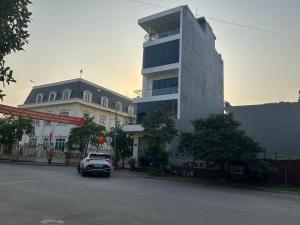 a car parked in front of a tall building at S23 homestay in Hai Phong