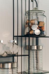 a glass shelf with a glass jar with medicines at Hambar Belis in Beliş