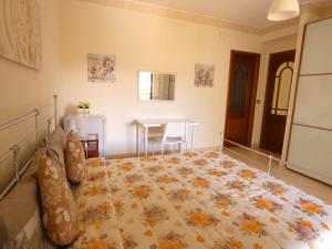 a bedroom with a large bed in a room at Villa Magnolia B&B in Taormina +4 photos